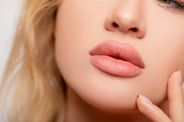 Fotobehang Beautiful lips Close-up. Makeup. Lip matte lipstick. Sexy lips. Part of face, young woman close up. Perfect plump lips bodily lipstick . p each color of lipstick on large lips. Perfect makeup  © Julia