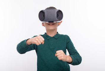 Young boy playing games with VR glasses