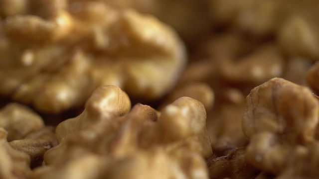 Walnut close up. product rich in minerals and vitamins. Walnut turns in a shot. Walnut kernels rotating. walnut close up lies under beams of the sun. Macro