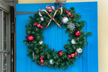 Christmas ornament on blue door.