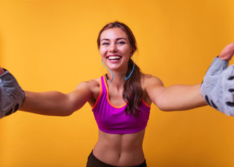 Image of a positive young brunette sports fitness woman posing isolated over white wall background take selfie by camera showing peace gesture.Attractive girl making a selfie after her exercise.