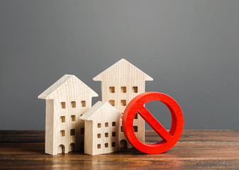 Apartment buildings and red prohibition symbol NO. Emergency and unsuitable for living building. Unavailable expensive housing. Lack of living space and the impossibility of building a new houses.