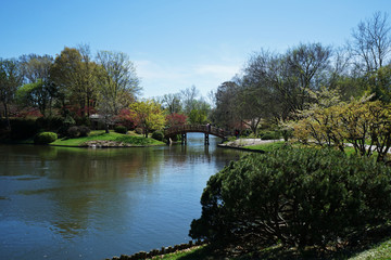 Traditional wooden bridge with garden arranged in Japanese Zen style