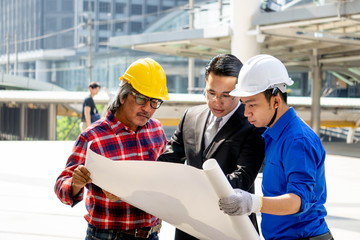 Businessman or boss manager in suit meeting with engineer outdoor