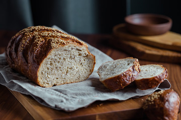 Whole grain loaf bread with chia seeds on a cutting board. Healthy eating concept.