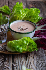 Fresh baby radicchio and lettuce with white bean dressing  and sunflower seeds