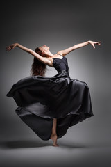  Girl dancer in an elegant, unusual pose. Beautiful girl with long hair in black clothes from a long skirt, dance, uniform, sport, ballet, modern, beautiful, amazing, passion, sexy, unusual, silk