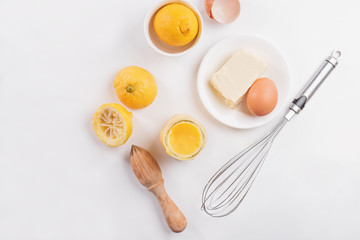 Lemon curd in a glass jar on a white background, ingredients for cooking, lemon kyrd recipe