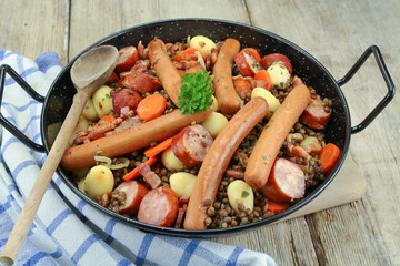 sausage and lentils dish on a wooden table