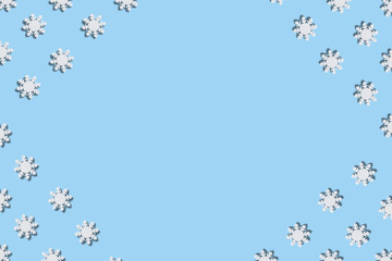 Christmas and New Year pattern made of wooden snowflakes on a blue background. Christmas, winter, new year concept. Flat lay, top view, copy space
