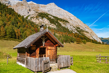 Beautiful alpine autumn or indian summer view with a wooden hut at the famous Big Maple Ground, Tyrol, Austria