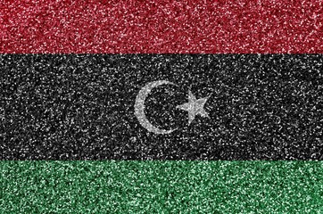 Libya flag depicted on many small shiny sequins. Colorful festival background for party