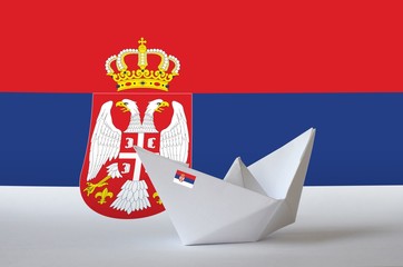 Serbia flag depicted on paper origami ship closeup. Handmade arts concept
