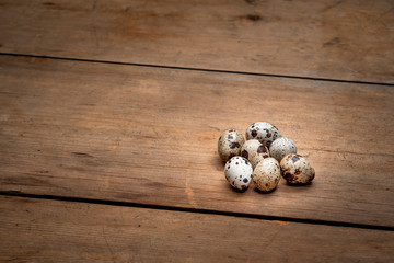 Quail eggs on an old wooden table copy space