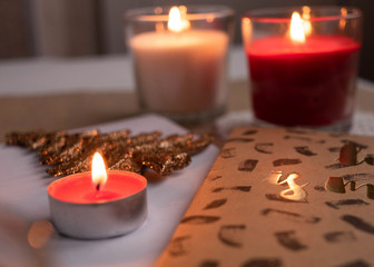 New Year composition with toys, candles and notebooks