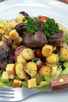 plate of gizzard salad and potatoes