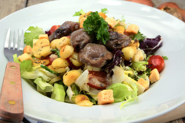plate of gizzard salad and potatoes
