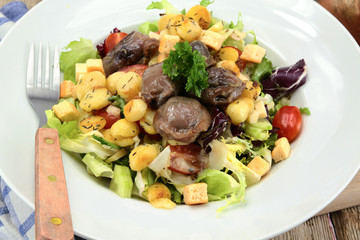 plate of gizzard salad and potatoes