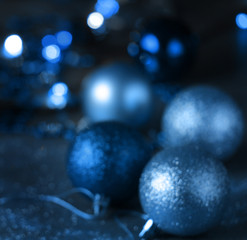 Christmas blue background with bokeh, lights and Christmas balls. defocus. blurred focus. copy space