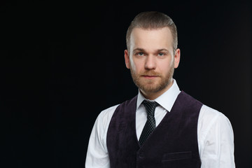 Elegant bearded man in stylish clothes Isolated on a black background.