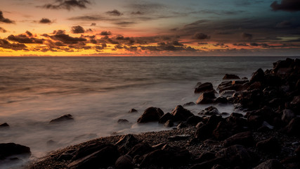 Fototapeta premium colorful sunset over rocky beach on madeira