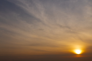 Fototapeta na wymiar Blue sky behind cloud scape and the morning sun.