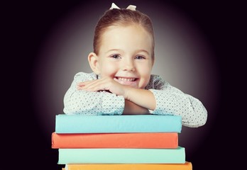 Back to school! Happy cute industrious child indoors. Kid in class on background of blackboard.