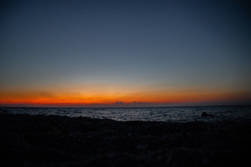 Fototapeta na wymiar orange red sunset at the beach