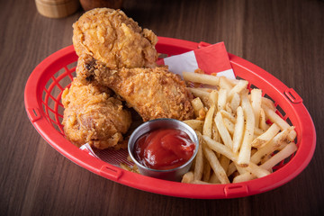 fried chicken with french fries in plastic basket