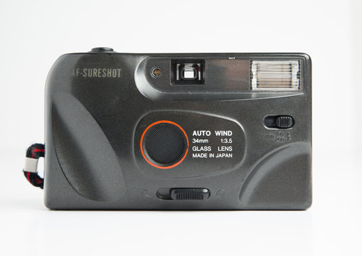london, england, 05/05/2019  a retro vintage 1990s Canon Sure shot Auto Focus AF 7 f 35 mm film camera isolated on a white background. Canon 4.5 lens, old photographic technology analogue. 