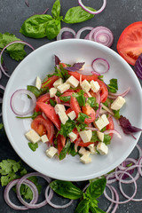 Vegetable salad with cheese, on a white plate
