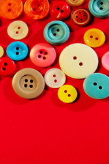 Abstract colorful background. Multi-colored buttons over red background, copy space for text. 