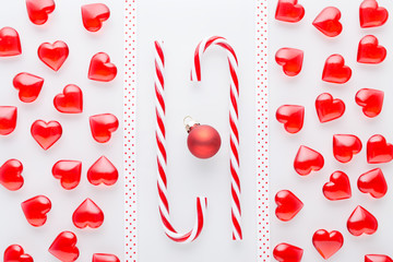 white background with red hearts, bauble and christmas candy cane