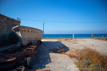 abandoned boat beside the beach