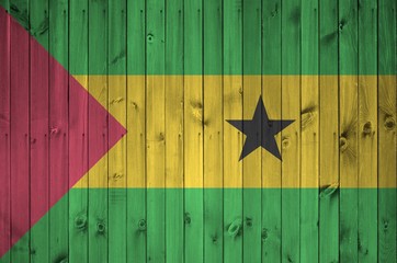 Sao Tome and Principe flag depicted in bright paint colors on old wooden wall. Textured banner on...