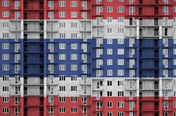 Thailand flag depicted in paint colors on multi-storey residental building under construction....