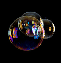 Rainbow soap bubbles isolated on black background