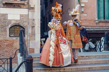 Fototapeta na wymiar Masked and dressed up couple posing