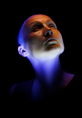Artistic portrait of a lady created by multicolor light on a black background