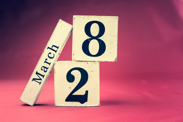 March 28th, Twenty-eighth of March, Day 28 of month March - vintage wooden calendar blocks on maroon background with empty space for text