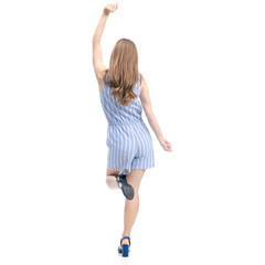 Fototapeta premium Woman in blue overalls fashion happiness dancing smiling on white background isolation, back view