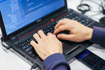 programmer coder working on his laptop. Software development. Programmer coding web application...