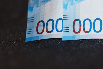 Zeros on Russian two thousandth notes of a new sample. Dark background. To articles on finance,...