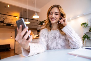 Beautiful pretty young blonde woman using mobile phone