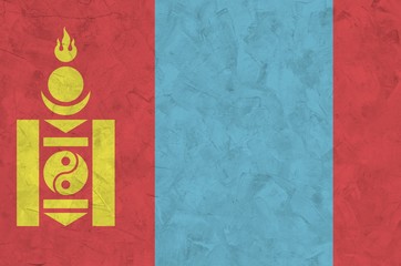 Mongolia flag depicted in bright paint colors on old relief plastering wall. Textured banner on...