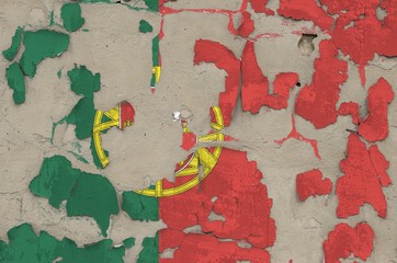 Portugal flag depicted in paint colors on old obsolete messy concrete wall closeup. Textured banner on rough background