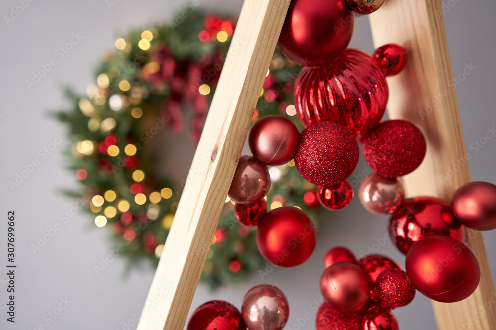 Wall mural Close up red christmas balls. Alternative wooden christmas tree. A handmade Christmas tree.