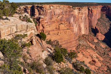 Landscape of red cliffs and valley at Canyon de Chelly National Monument in Arizona