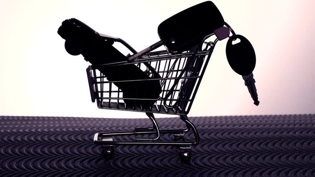 Backlit model shopping trolley holding a model car. Keys are added to illustrate the concept of a car purchase.