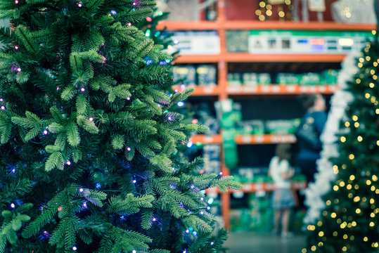 Shallow DOF customer shopping for artificial Xmas at hardware store in USA
